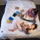 Frau sitzt nachts auf dem Bett und arbeitet, während ihre Tochter neben ihr schläft, Blognacht, produktiv bloggen, Networking